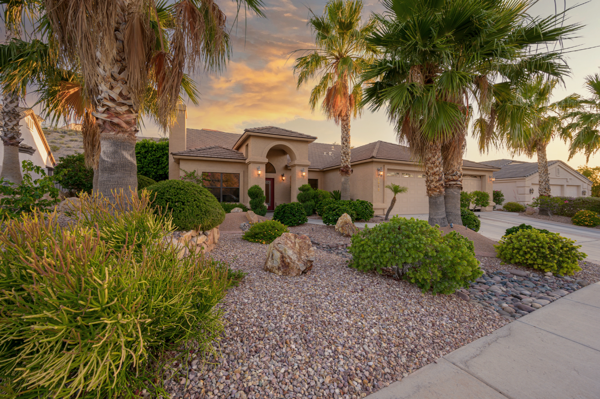 Beautiful Arizona home during golden hour surrounded by palm trees