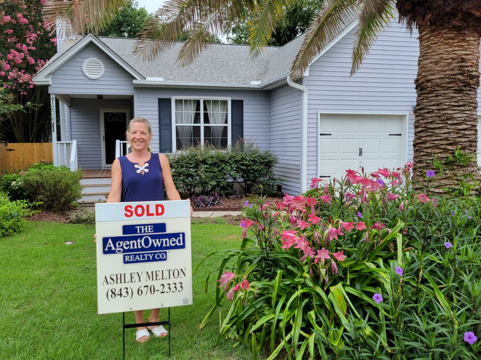 charleston sc real estate agent ashley melton in front of a sold home