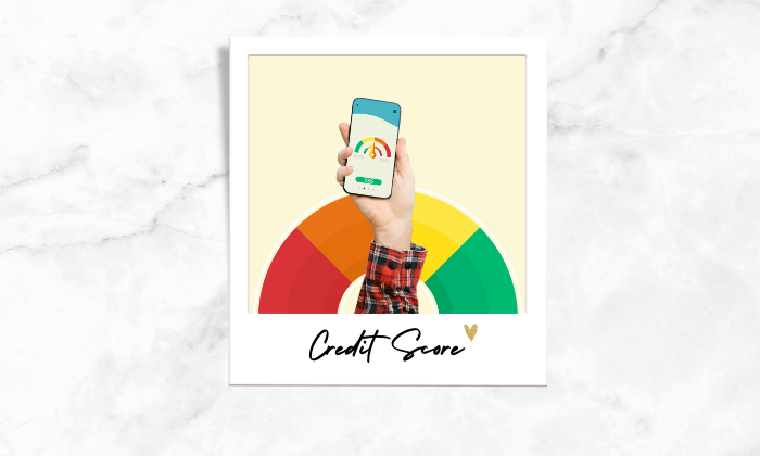 Photo of a person holding a phone showing a credit score