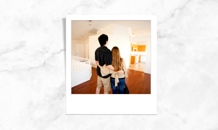 Photo of a couple looking at a house