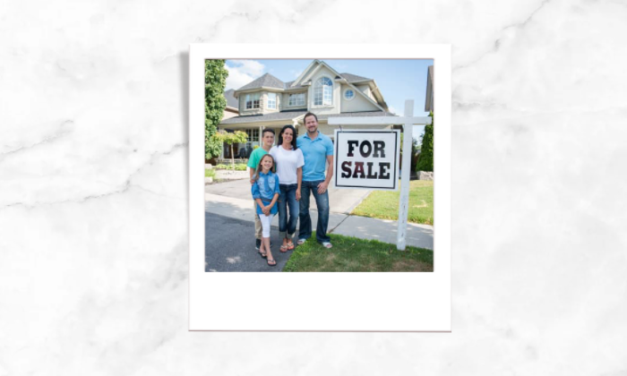 Photo of a family in front of a for sale house
