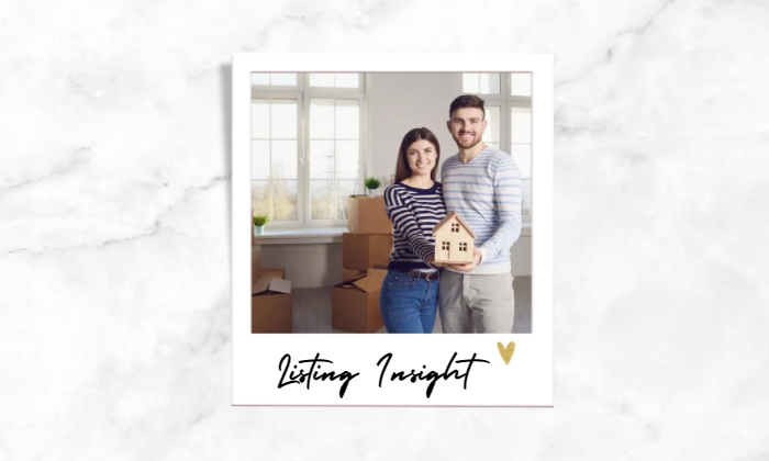 Photo of a couple holding a house model