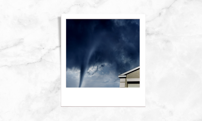 A photo of a tornado near a house