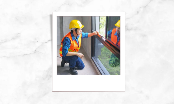 Photo of a person inspecting the house while kneeling