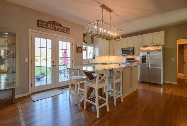 Bright white kitchen with hardwood floors and subway tile in Indianapolis, IN