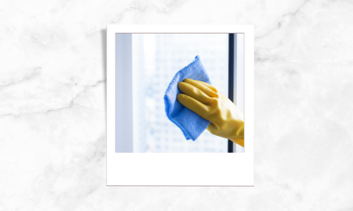 Photo of a person wiping the window glass