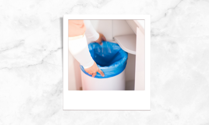 Photo of a person cleaning the trash bins