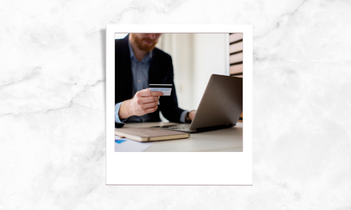 Photo of a man looking at his credit card