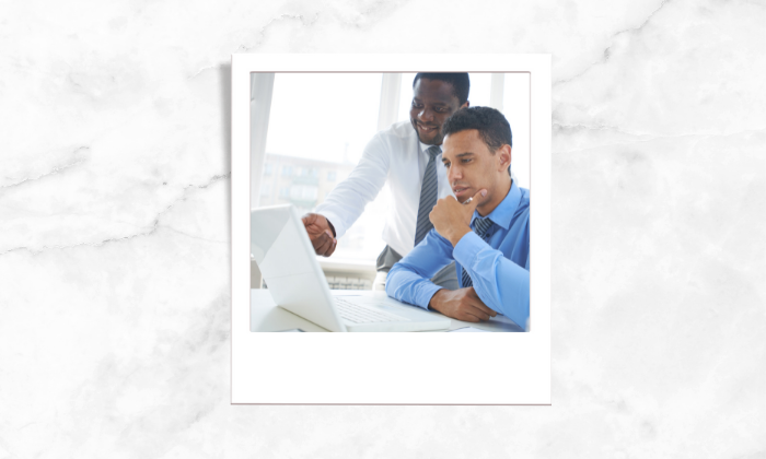 Photo of two people studying at a laptop