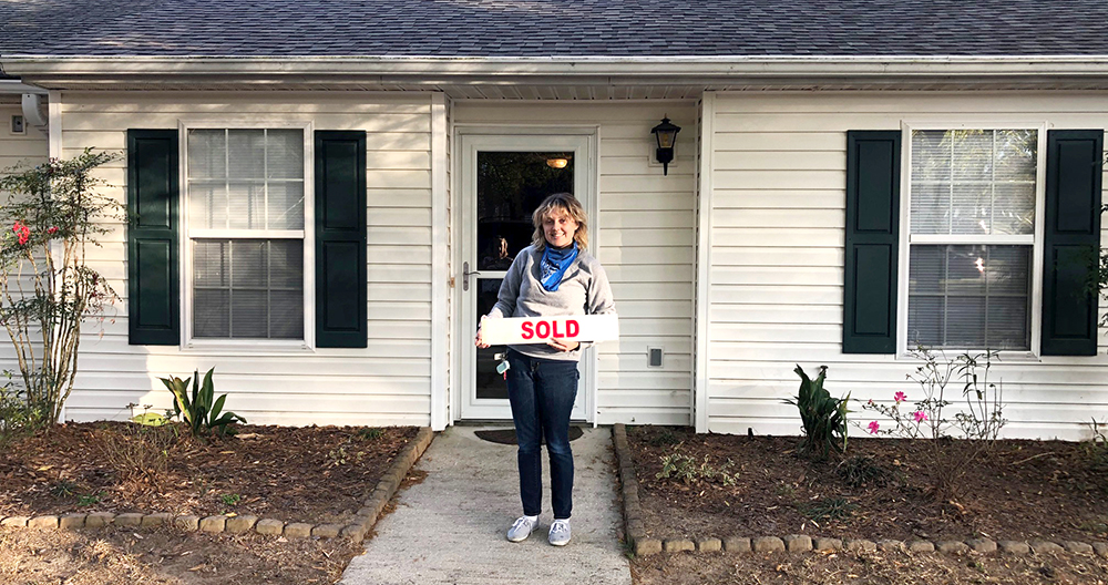 home-buyer-with-sold-sign