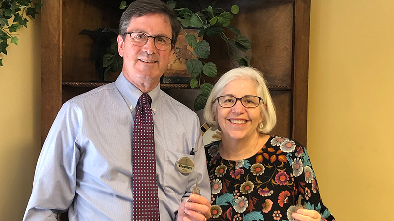 husband and wife with keys to their new home