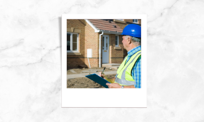 Photo of a surveyor assessing the house