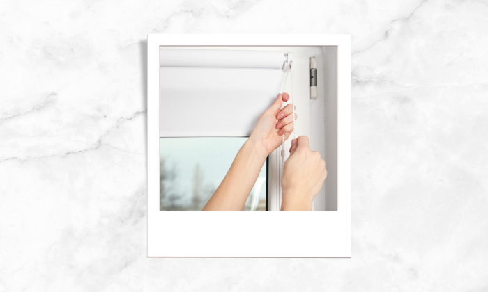 Photo of a person using the window blinds