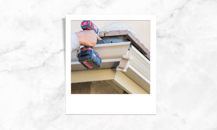 Photo of a person fixing the gutter