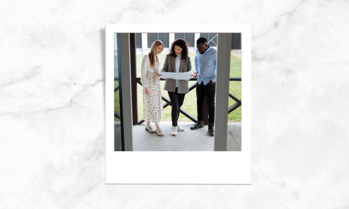 Photo of a realtor together with her clients