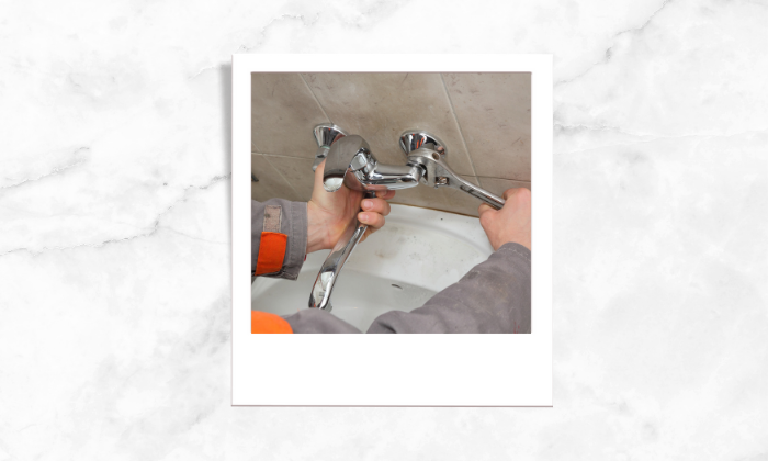 Photo of a person fixing the faucets