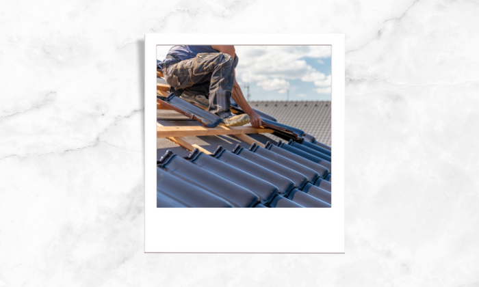 Photo of a person fixing the roof tiles
