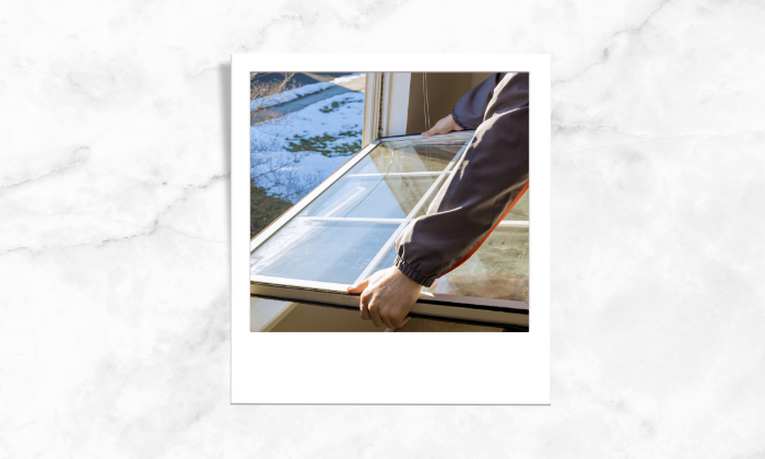 Photo of a person fixing the windows