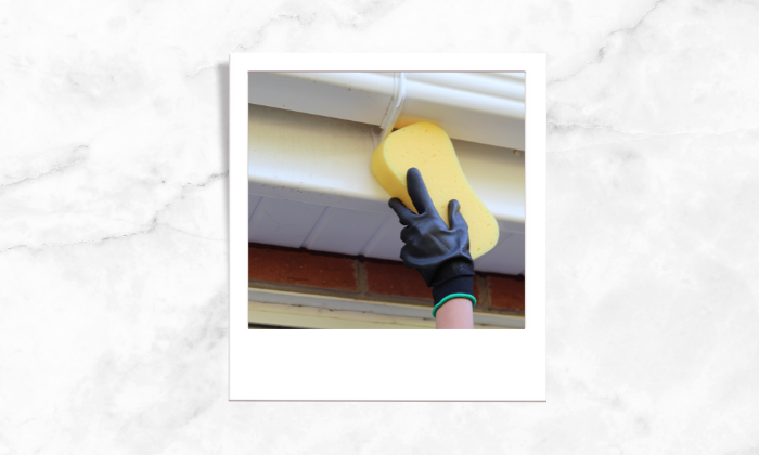 Photo of a person cleaning the fascia and soffit
