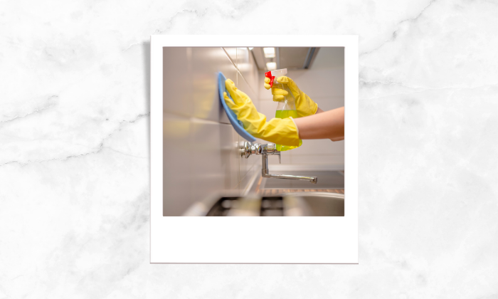 Photo of a person cleaning the kitchen sink