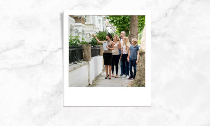 Photo of a realtor making a tour for her clients