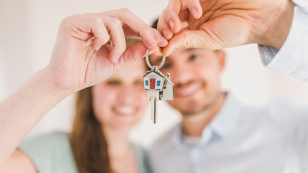 Couple with keys to their new home