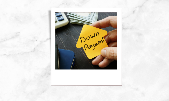 Photo of a person holding a note with a written words of Down Payment