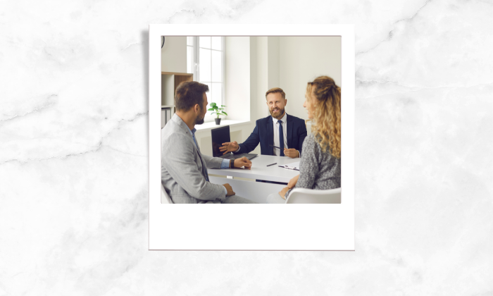 Photo of a couple consulting their realtor