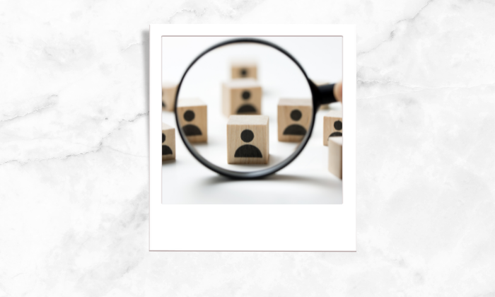 Photo of wooden blocks being viewed using a magnifying glass