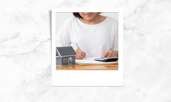 Photo of a woman signing papers
