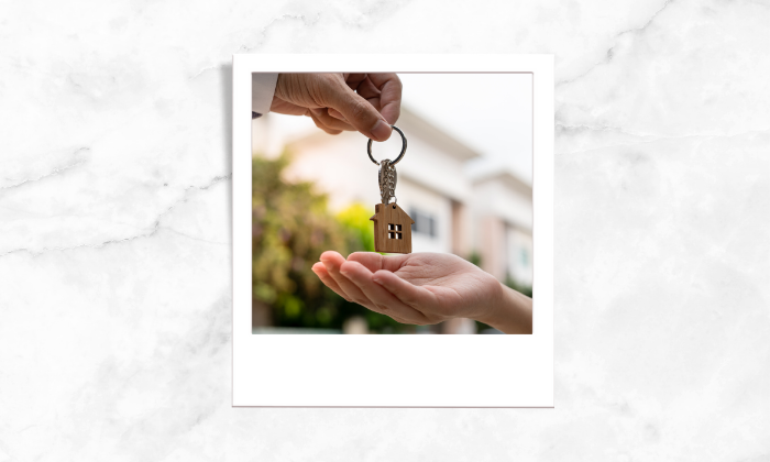 Photo of two people handing a key chain