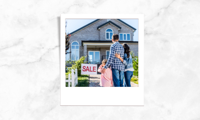 Photo of a family looking at a for sale house
