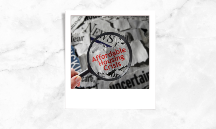 Photo of a magnifying glass highlighting affordable housing crisis