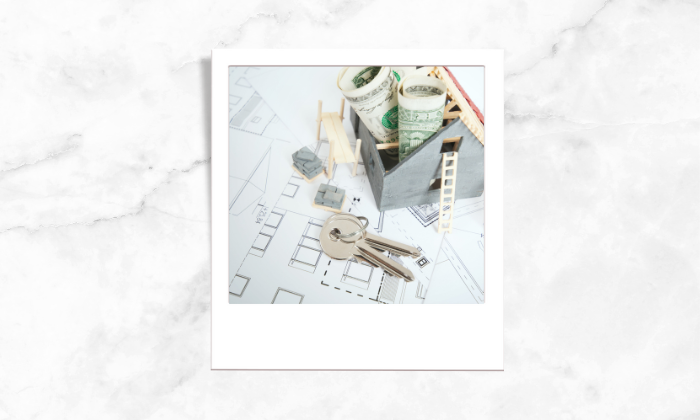 Photo of house keys above the blueprint of the house