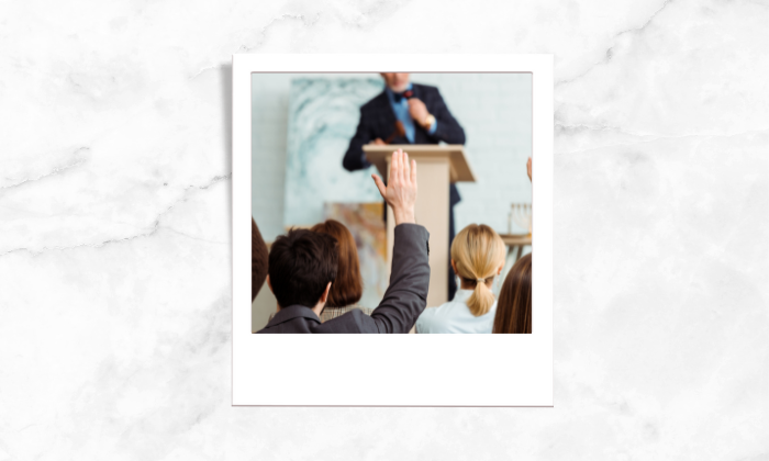 Photo of a man raising his hand in a bidding