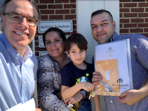 Happy family with child smiling next to David Campbell.