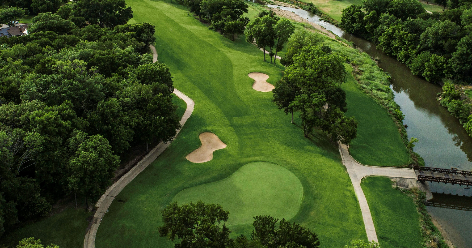 Aerial view of a fairway and bridge over pond