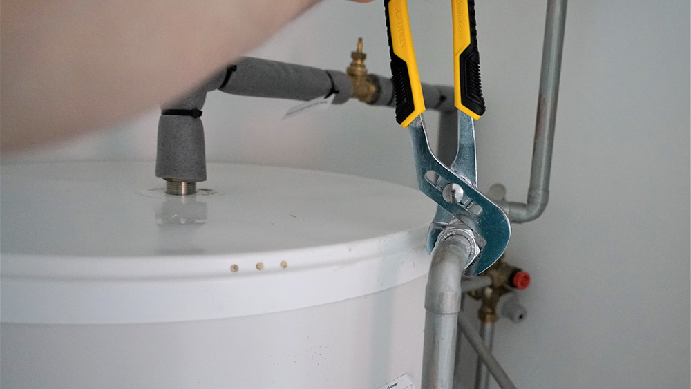 plumber repairing pipes to a water heater