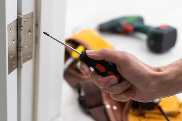 a-locksmith-is-repairing-an-interior-door-lock-cl-2023-06-23-05-46-40-utc