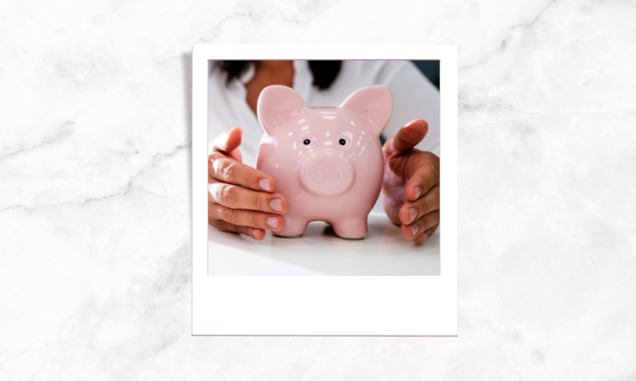 A photo of a woman holding a piggybank