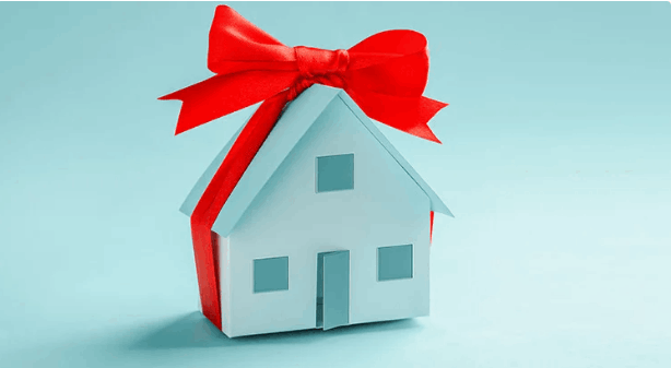 House wrapped in red holiday bow