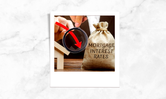 A photo of a money bag and a magnifying glass showing the interest rates are going down