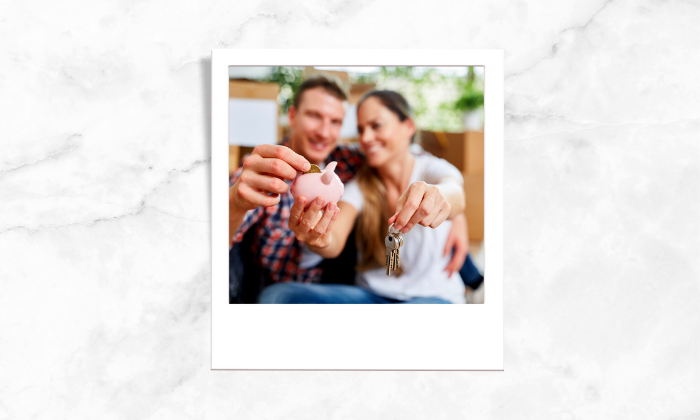 A photo of a couple holding a key and a piggybank