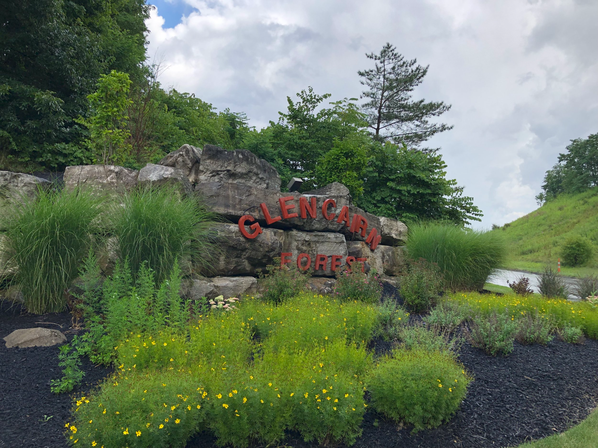 Stone monument sign reading "Glencairn Forest" in red, located near homes for sale in Glencairn Forest Ohio