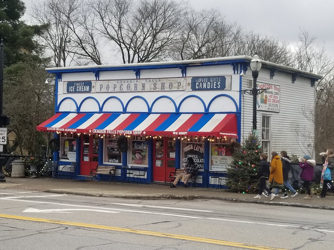 popcorn shop, white building with blue window and decor, red white and blue awnings