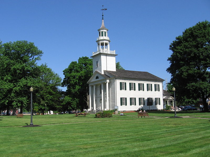 Side view of Tallmadge city hall, a colonial style white building with a tall cupola above the main entrance located near homes for sale in Tallmadge Ohio