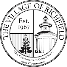 Richfield logo, a black and white circle reading The Village of Richfield Ohio around the outer circle, and in the inner circle reading Est.1967, a tree and a silhouette of the small clock tower, located near homes for sale in Richfield Ohio