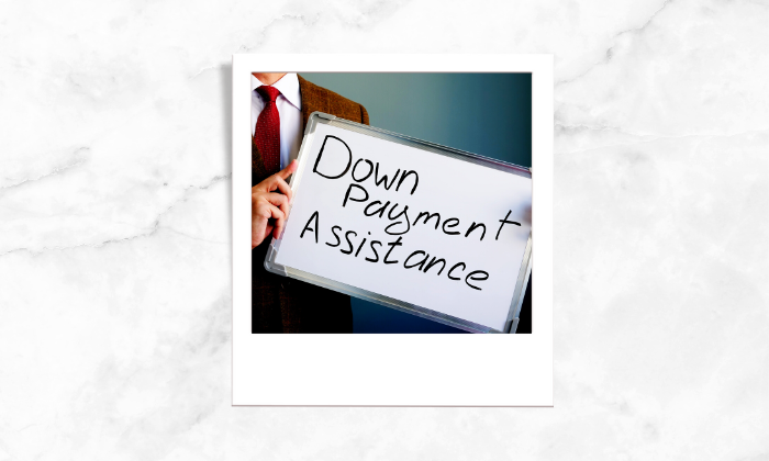 Photo of an individual with a down payment assistance signage