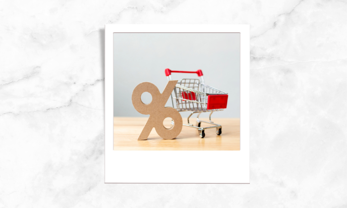 Photo of a percentage sign and a shopping cart