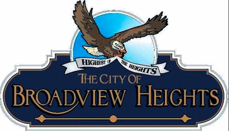 Logo of city, blue banner sign that reads The City Of Broadview Heights in gold letters, with a picture of a flying eagle on top and a second banner below that read Highest of the Heights located near homes for sale in Broadview Heights Ohio